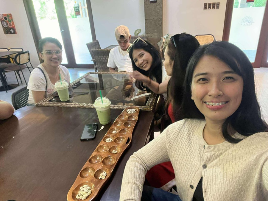SimplyVA assistants playing a board game over matcha drinks at a café